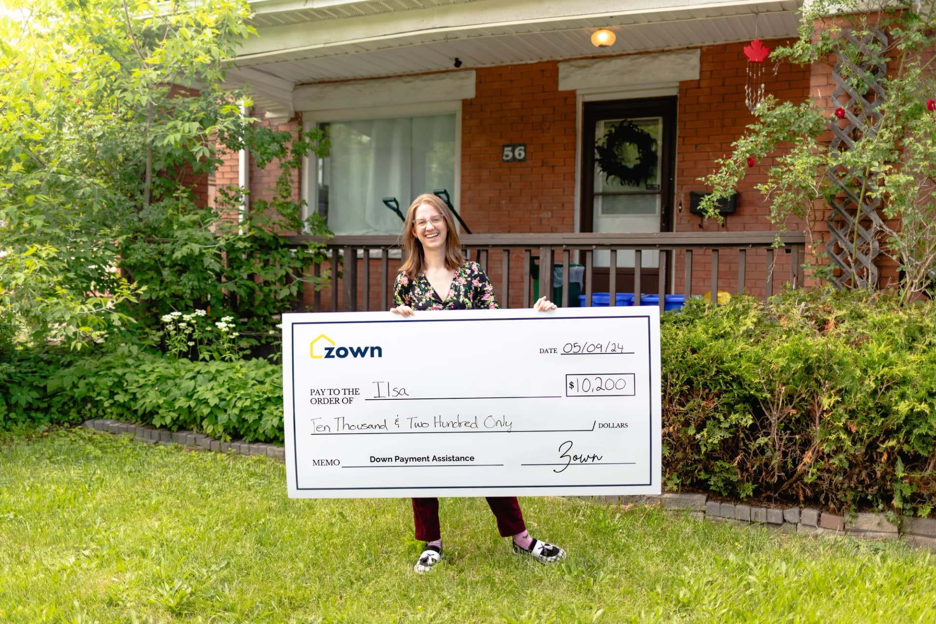 Ilsa holding their Zown boost cheque